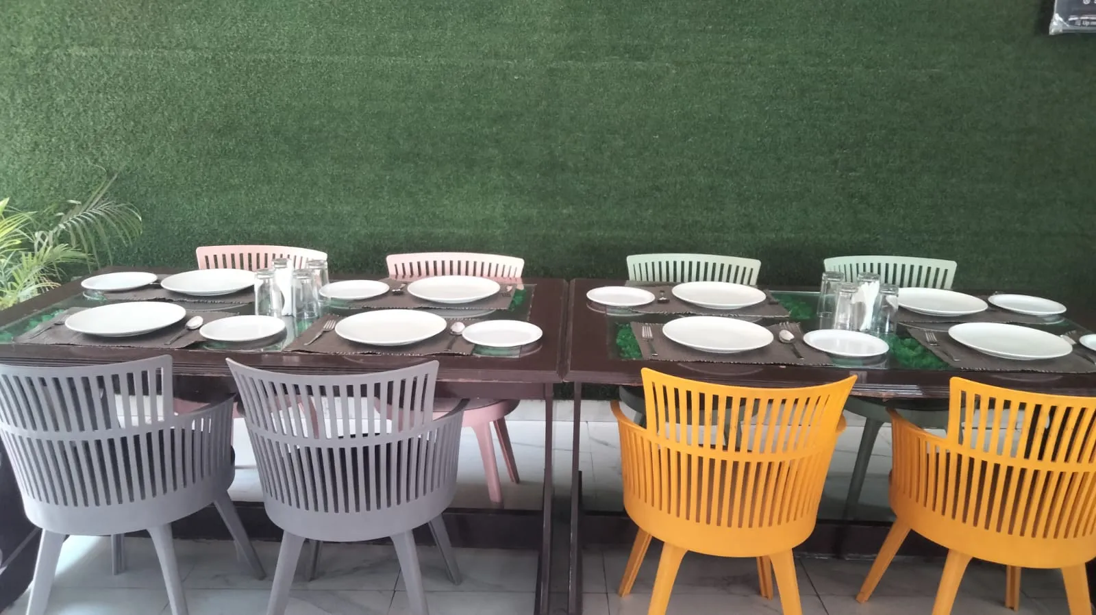 A table laid inside the restaurant, looking out through the open doorway to the courtyard