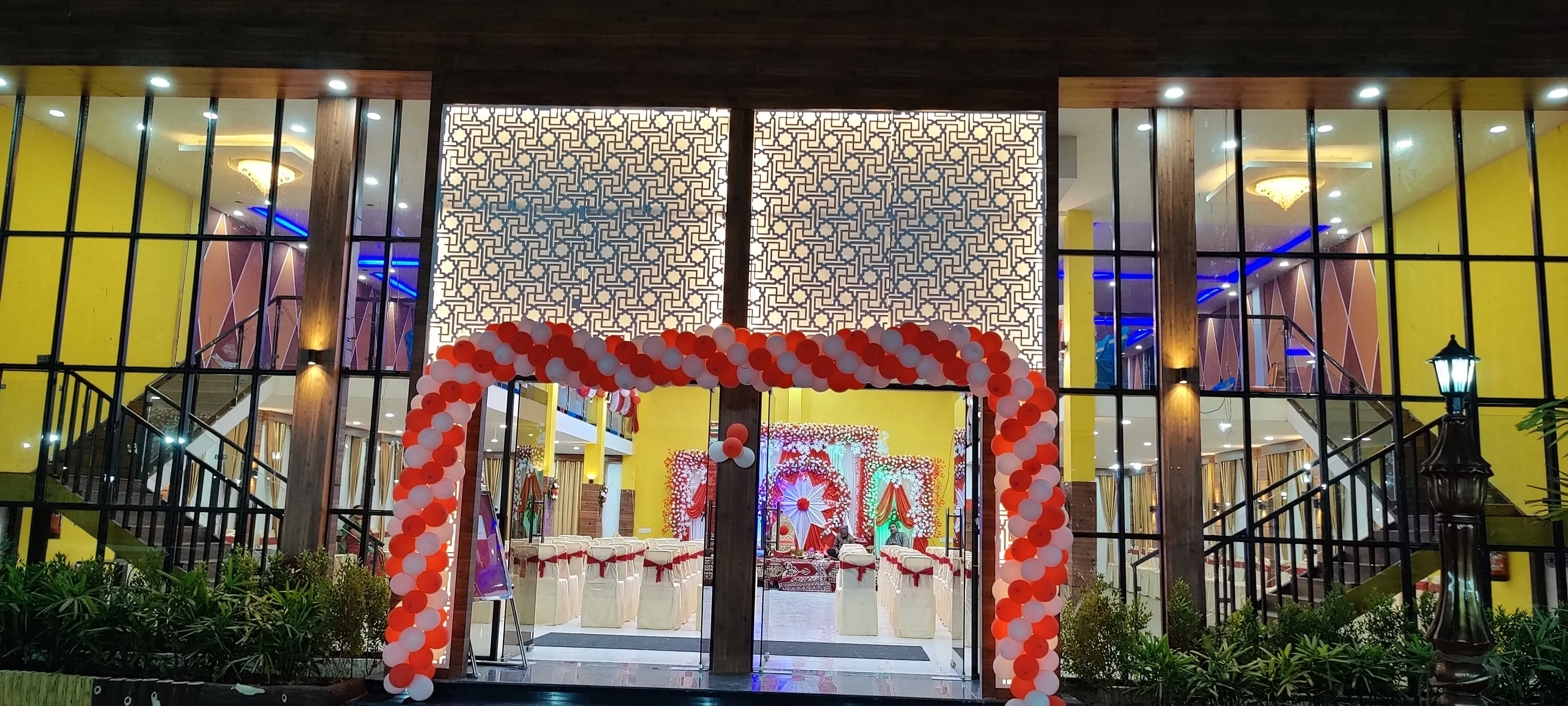 Venue entrance decorated with a balloon arch at night