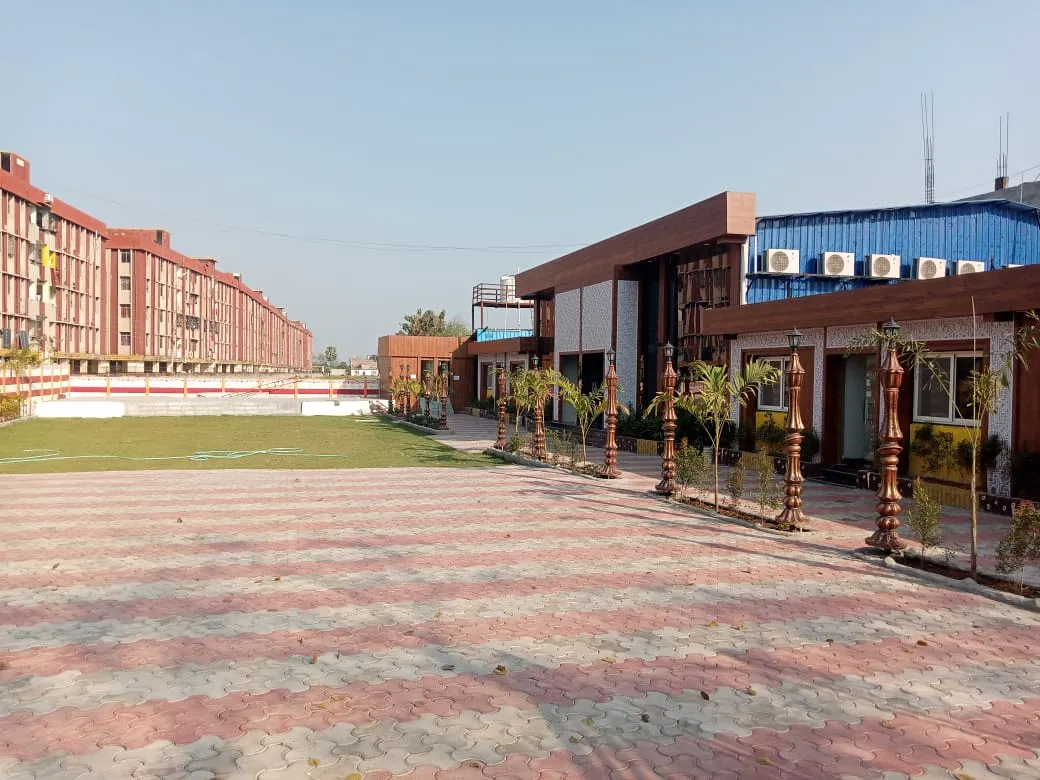 Daytime view of the property's grounds and guest-room block, opposite the airport road
